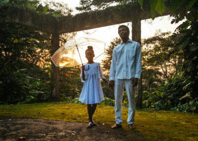 Esi and Kojo stand in a garden.